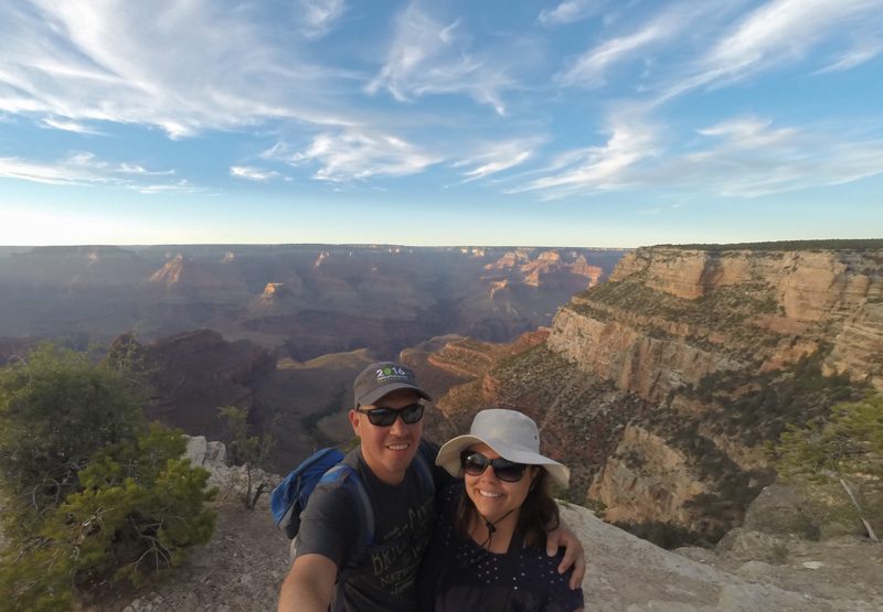 Manu and Adriane standing in front of the Grand Canyon